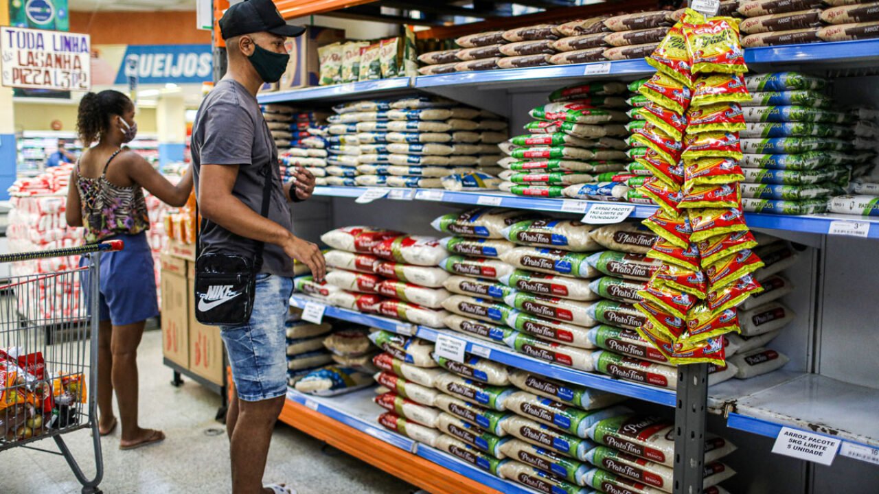 People look on as bags of rice are seen displayed at a supermarket in Rio de Janeiro, Brazil,  September 10, 2020. REUTERS/Pilar Olivares