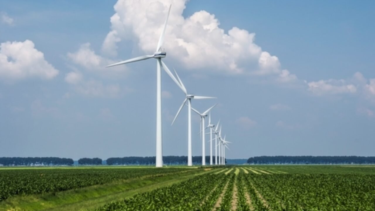 A beautiful view of the wind turbines on a grass covered field captured in Holland