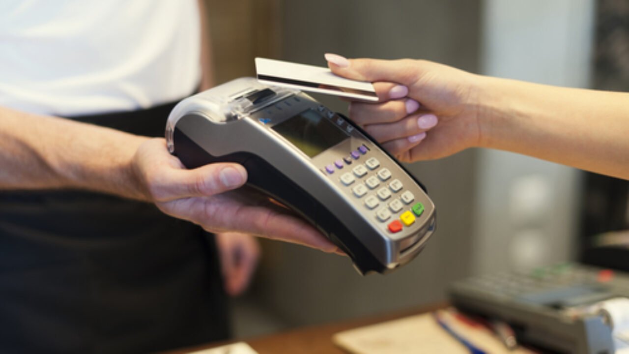 Close up of customer paying by credit card