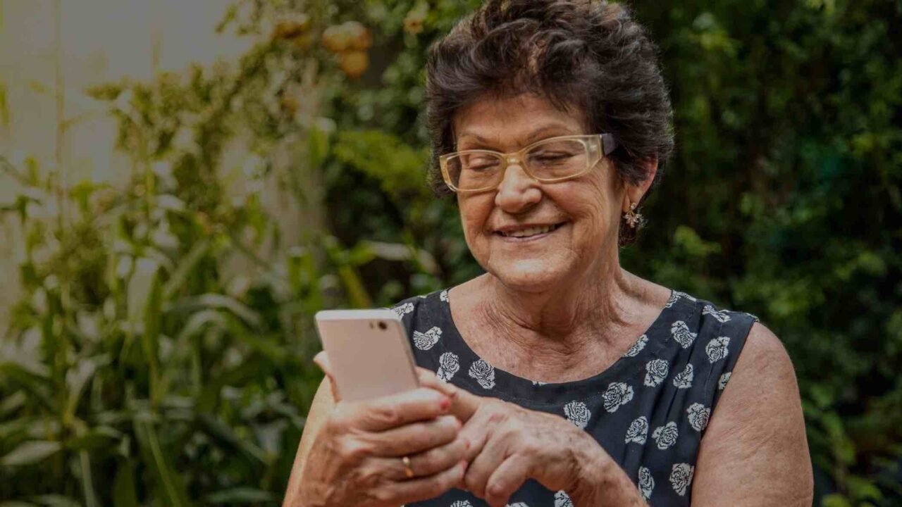 happy elderly woman using cellphone