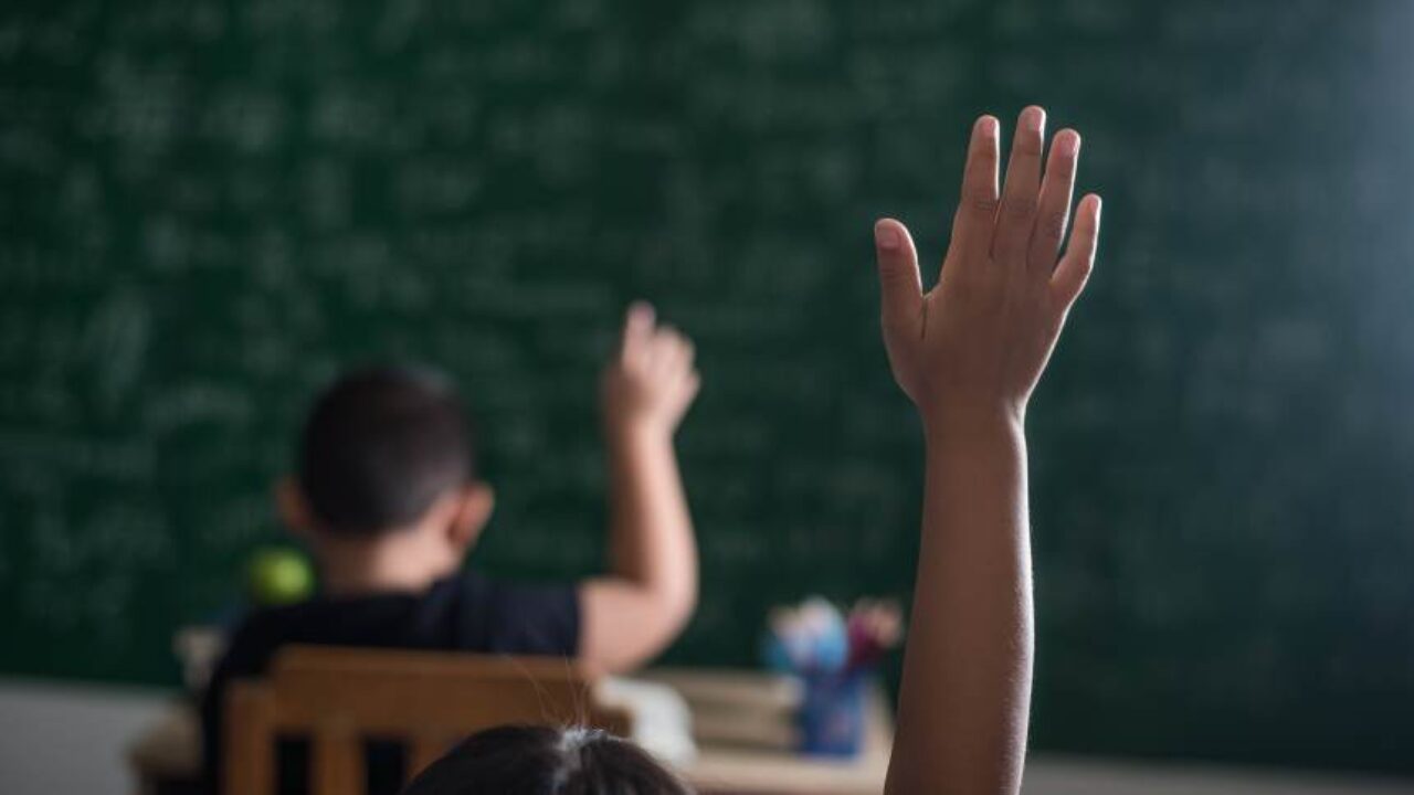 kid-raising-his-hand-in-classroom