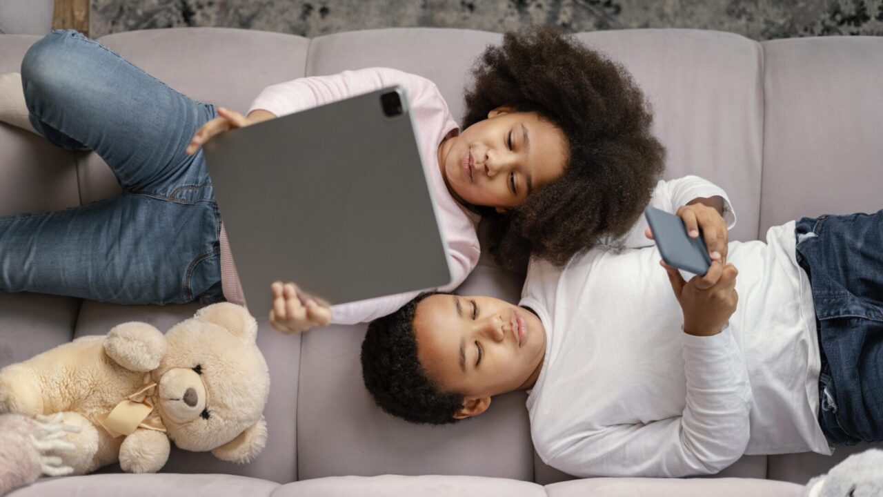 siblings-using-tablet-mobile-home